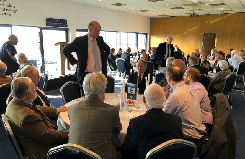 Chris Grayling talking to a table of guests.